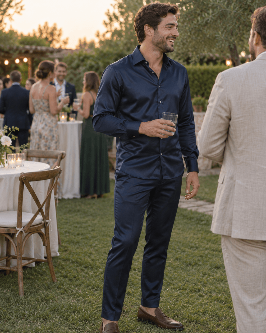 Navy men’s matching shirt and trousers set at a garden wedding