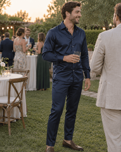 Navy men’s matching shirt and trousers set at a garden wedding